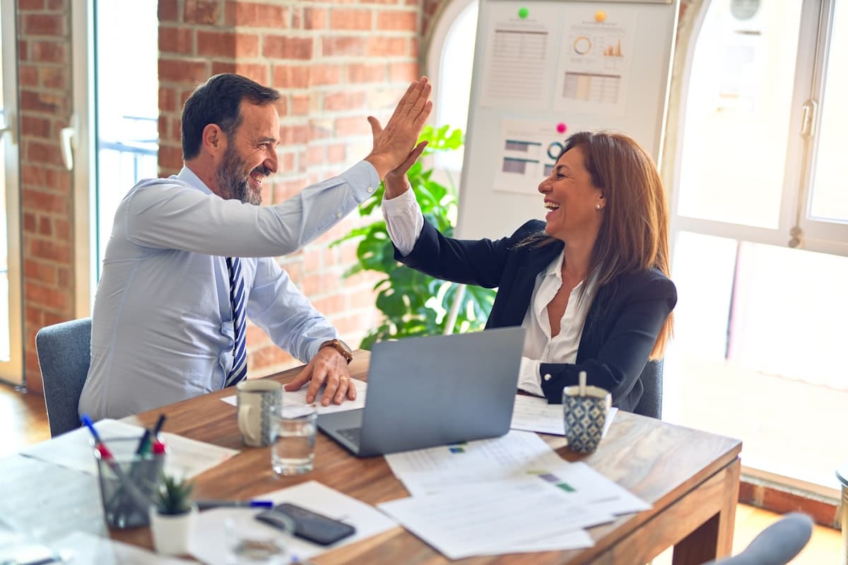 Two colleagues celebrating a smooth onboarding